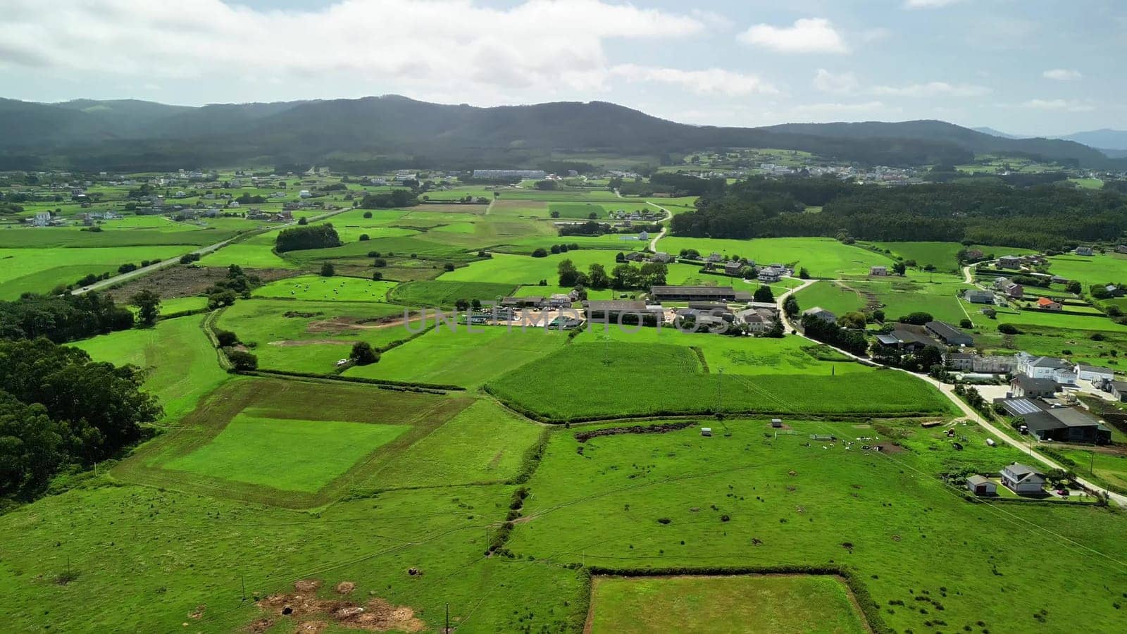 An absolutely stunning aerial view showcasing the vast, lush green fields along with serene rural landscapes