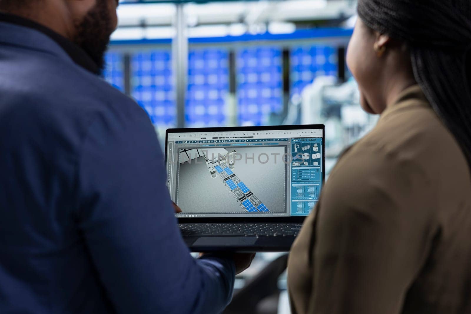 African american team of energy consultants analyzing insight in solar panel plant, ensuring high standards in renewable energy production line, quality control and manufacturing efficiency.