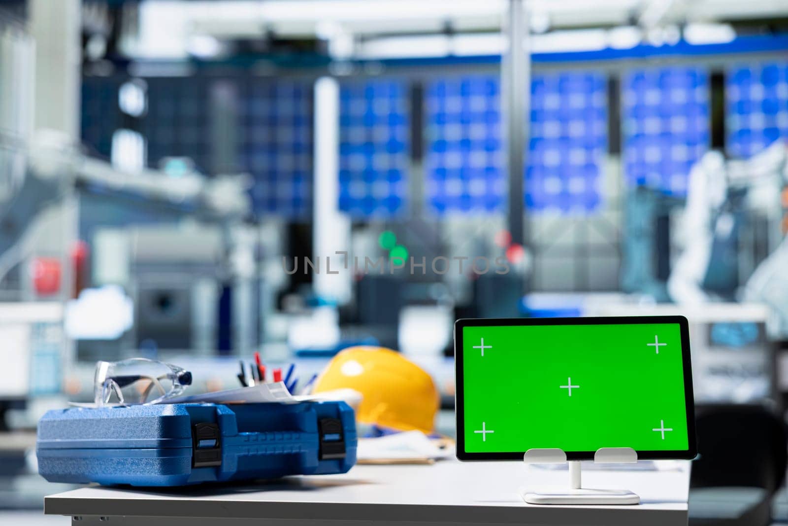 Chroma key display on PC in photovoltaics factory used to oversee production line, analyzing data and reviewing system metrics. Computer in solar panels plant, work on renewable energy.