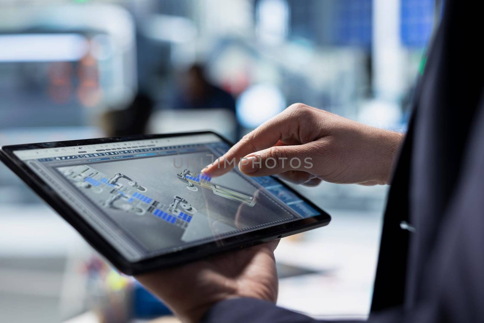 Solar factory expert monitors machinery performance on a production line, ensuring operational efficiency and supporting sustainable energy goals through professional diligence. Close up.