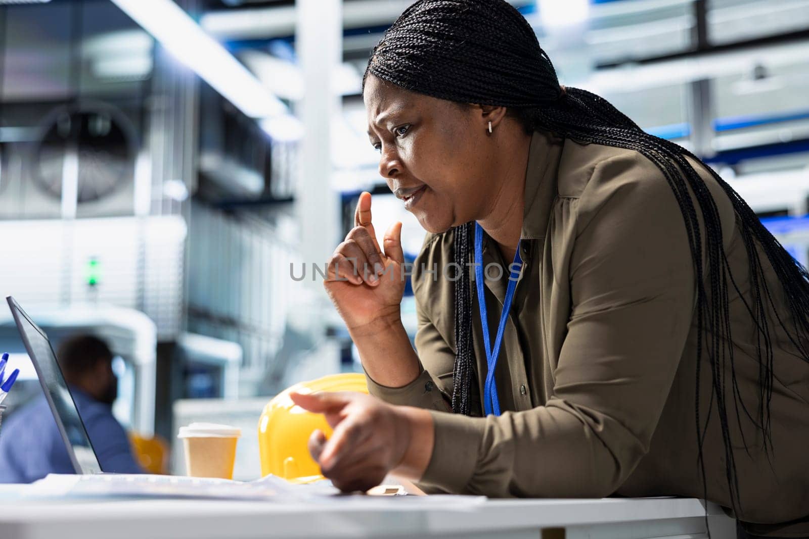 Female general manager reviewing production line system in a solar plant used for manufacturing, illustrating corporate leadership for sustainable energy in efficient industrial operations.