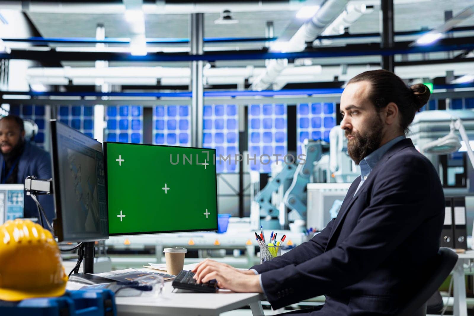 Male innovation consultant explores engineering upgrades with mockup in a solar panel facility, sustainable energy improvements and modern manufacturing processes for development.
