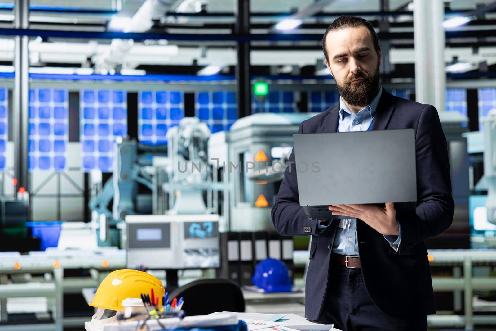 Executive consultant oversees solar energy systems in industrial workplace, emphasizing strategic planning for sustainable energy development. Innovation in clean power production line.
