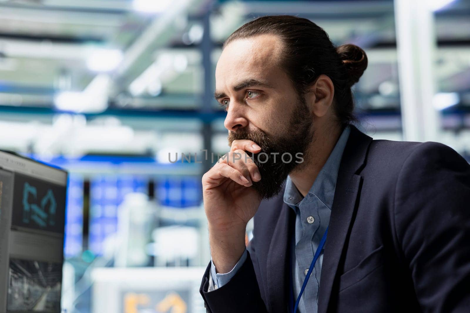 Male factory consultant observes production systems on a pc in a solar plant, providing expert feedback on efficiency, safety and sustainability aligned with green energy initiatives.