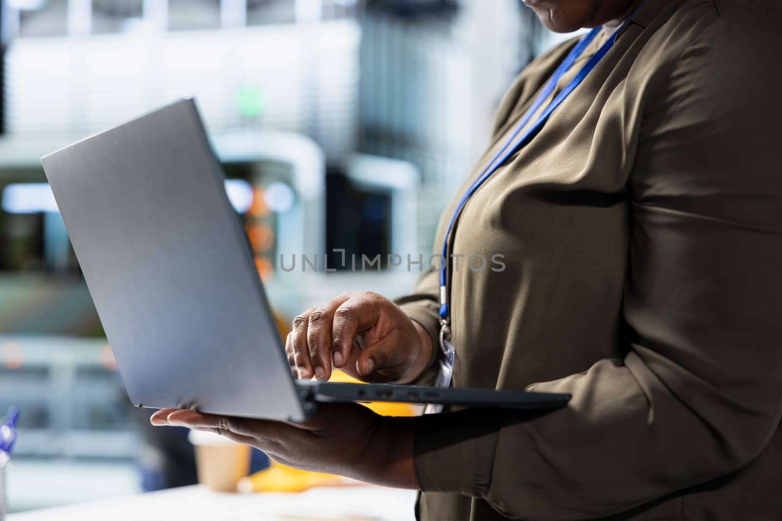 Woman professional checking system diagnostics in a solar panel plant used for manufacturing, illustrating corporate leadership for sustainable energy in efficient industrial operations.