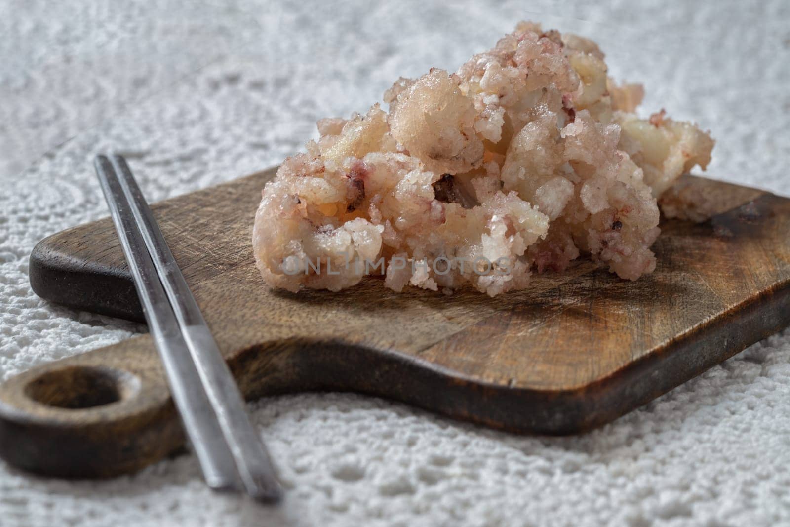Homemade Crispy And Crunchy Deep-Fried Squid or Deep-Fried Calamari and Silver chopsticks served on Wooden cutting board, use it as your Wallpaper, Poster and Copy space, Selective focus.