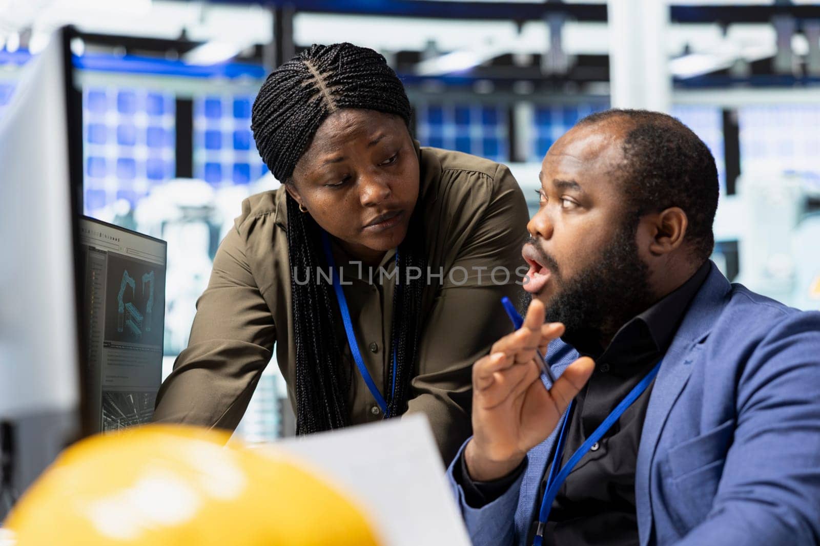 African American professional team working together in a solar plant, uniting forces to ensure efficient production of clean energy technology. Managing photovoltaics manufacturing.