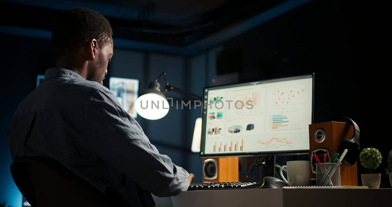 Network analyst studying digital commerce progression reports on computer, working at home to boost earnings and gain shareholder backing. Specialist analyzes company information. Camera A.