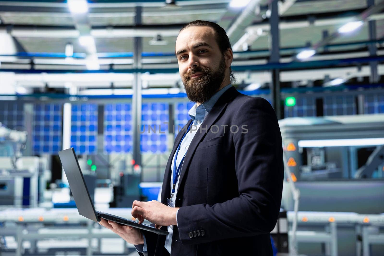 Solar panel industry expert stands in a high tech facility for inspection, quality control production metrics. Professional consultant ensuring industrial operations for innovation.