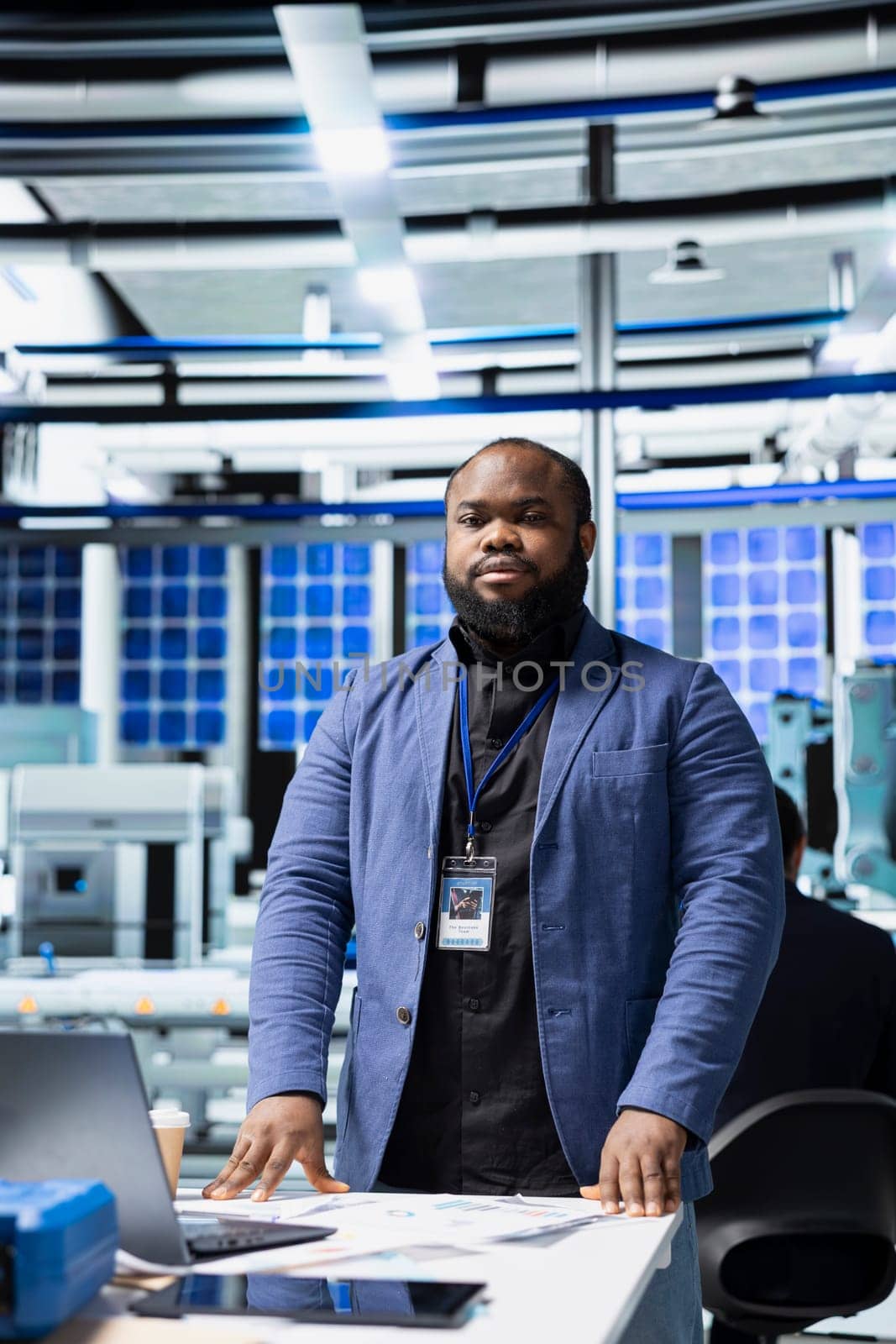 Solar panel male expert in suit ensuring the engineering within the manufacturing plant, reviewing the production line system for renewable energy goals. Sustainable solutions and development.