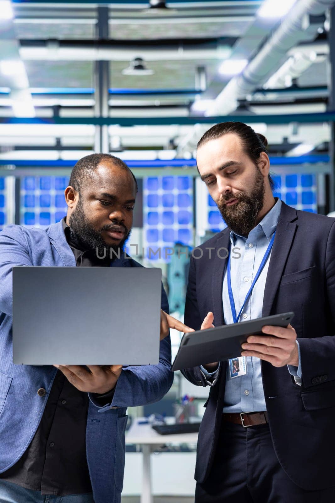 Multiethnic professional consultants engaging in a strategy meeting briefing on the production line, aligning corporate goals with renewable power engineering innovations. Photovoltaics.