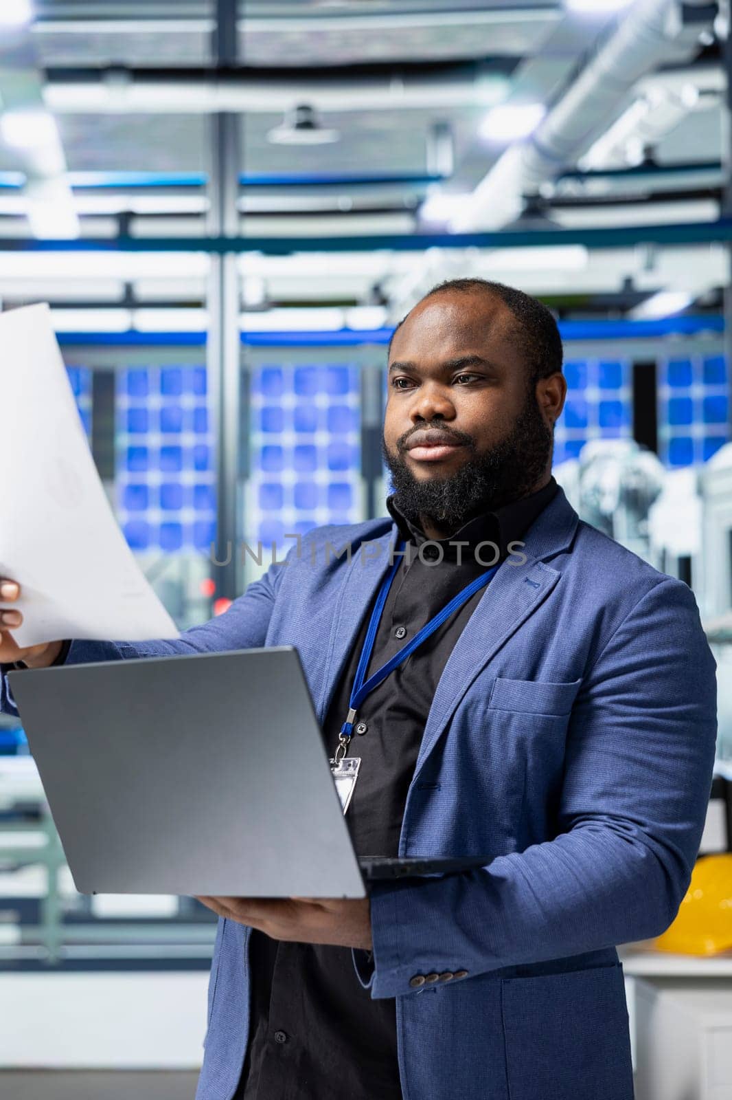 Factory employee checking solar panel machinery and reviewing a checklist, playing a vital role in renewable energy production and assembly line. Efficient solar tech infrastructure.