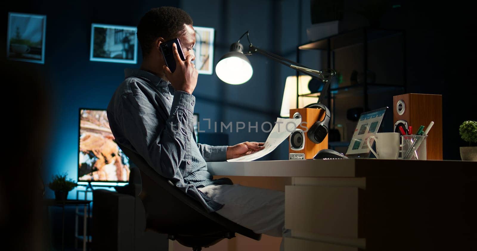 Male freelancer calling financial expert at home to discuss about monthly funds balance, increase profit with global investments. Young guy talking to advisor about capital resources. Camera A.