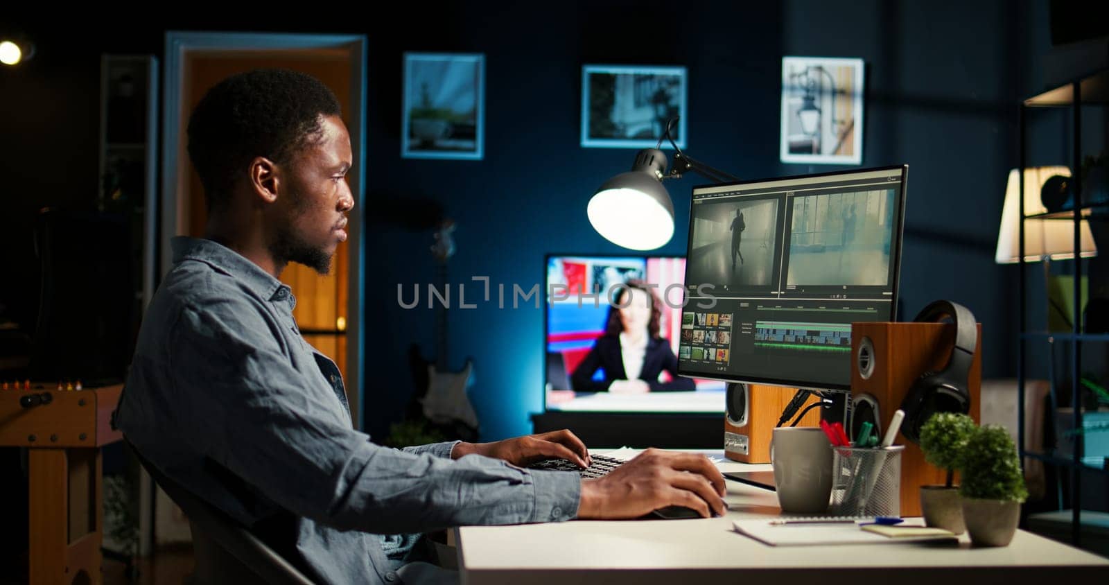 Young man video editor works on editing film footage at home setup, doing freelance contract for post production scenes. Editor correcting white balance and color grading, pc software. Camera A.