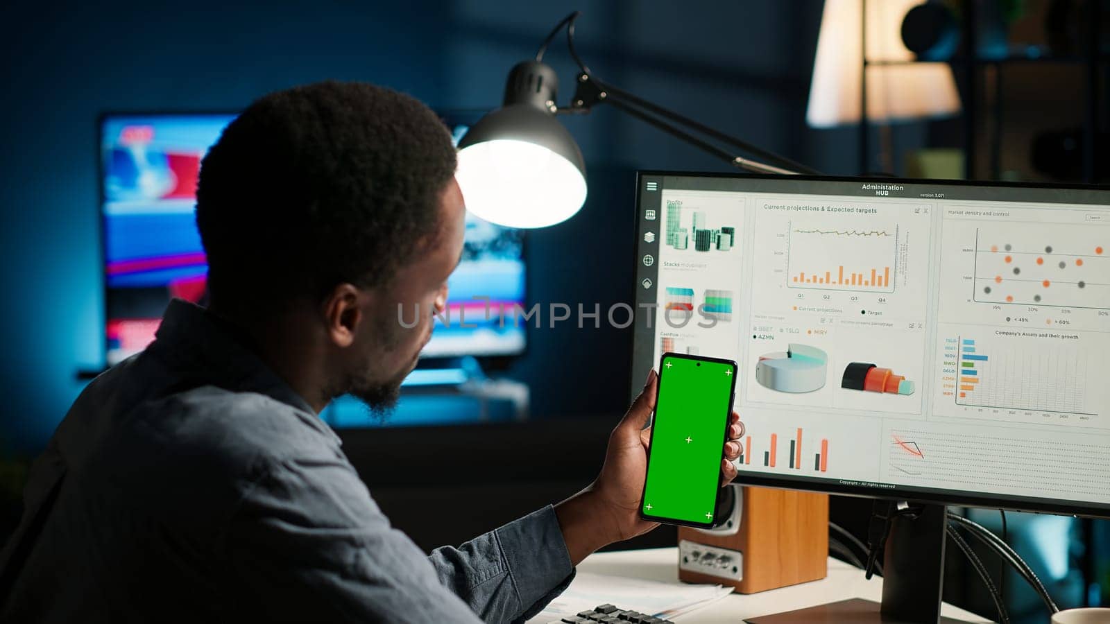 Financial manager doing accounting work on pc with chroma key screen, examining expenses for legal analysis at home setup. African american advisor working on reducing monthly costs. Camera B.