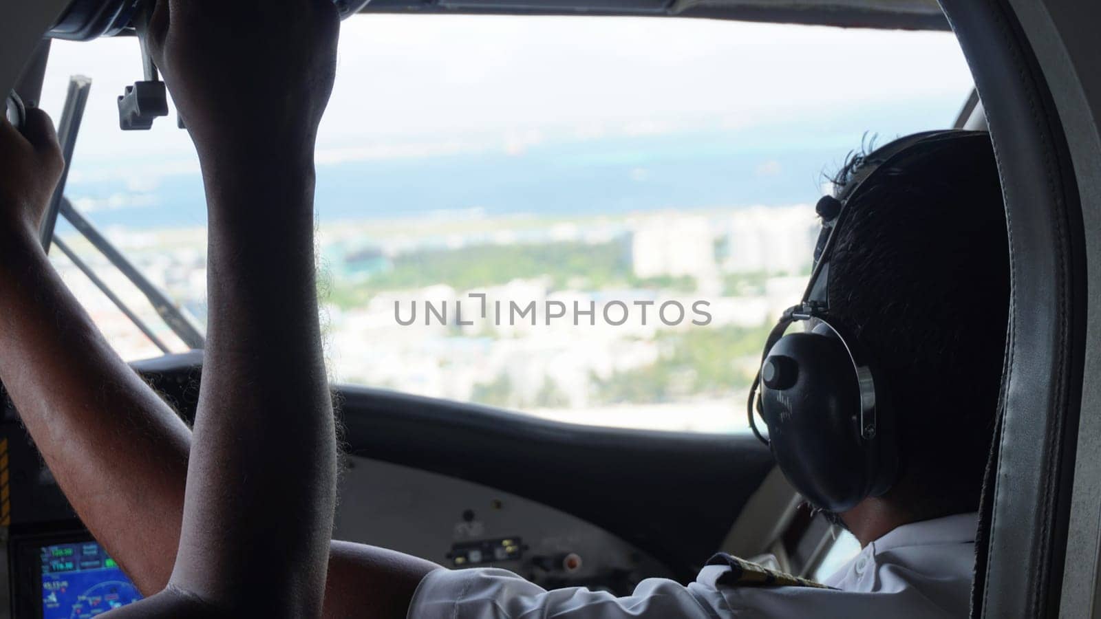 The pilot skillfully guides the aircraft towards the runway, offering a captivating view from the cockpit as they prepare for a smooth landing in a tropical paradise