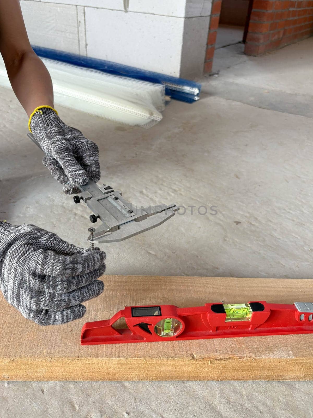 Caliper and level for measuring during construction of a residential building. Measuring tools at the construction site.