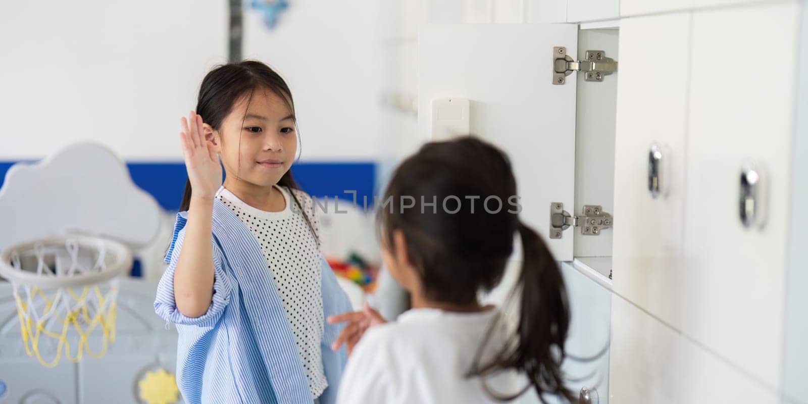 A girl greets her friend at the locker, showcasing camaraderie and excitement for the school day ahead.