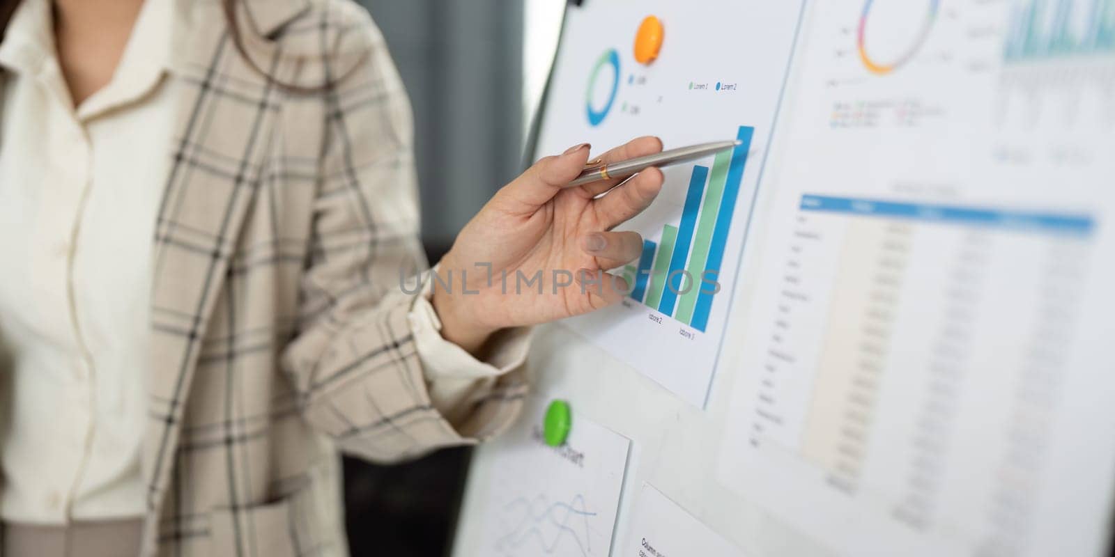 A professional presenting financial growth data on a chart, highlighting key performance indicators in business.