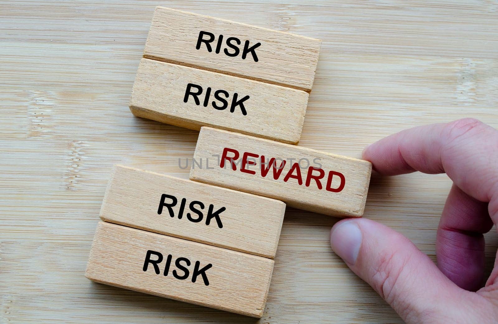 Risk and Reward text, depicting the classic decision making dilemma of weighing risk against reward in any venture.