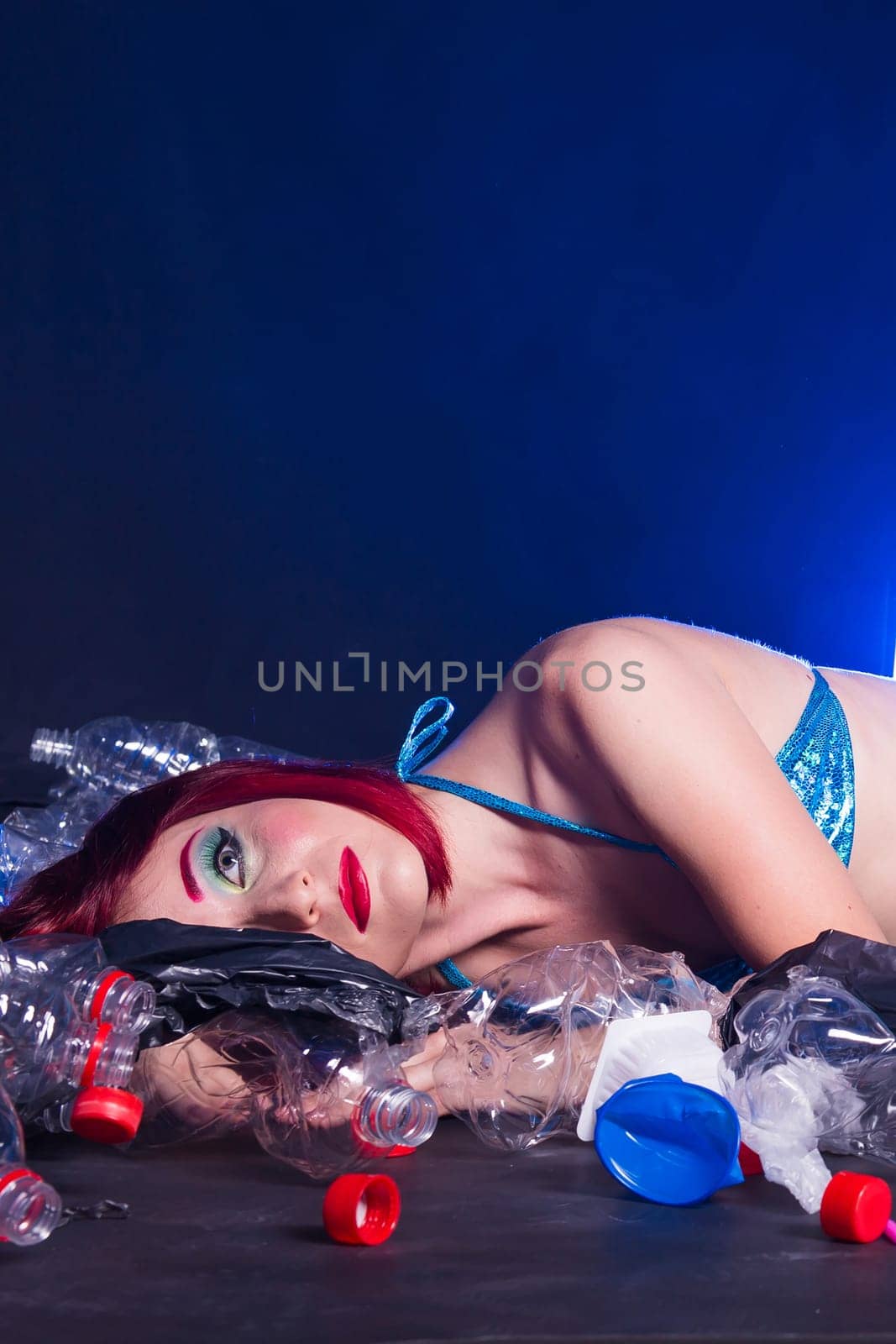 Ocean plastic pollution. Cute mermaid swimming in water with plastic garbage. Stop plastic pollution. Fairy tale and reality concept