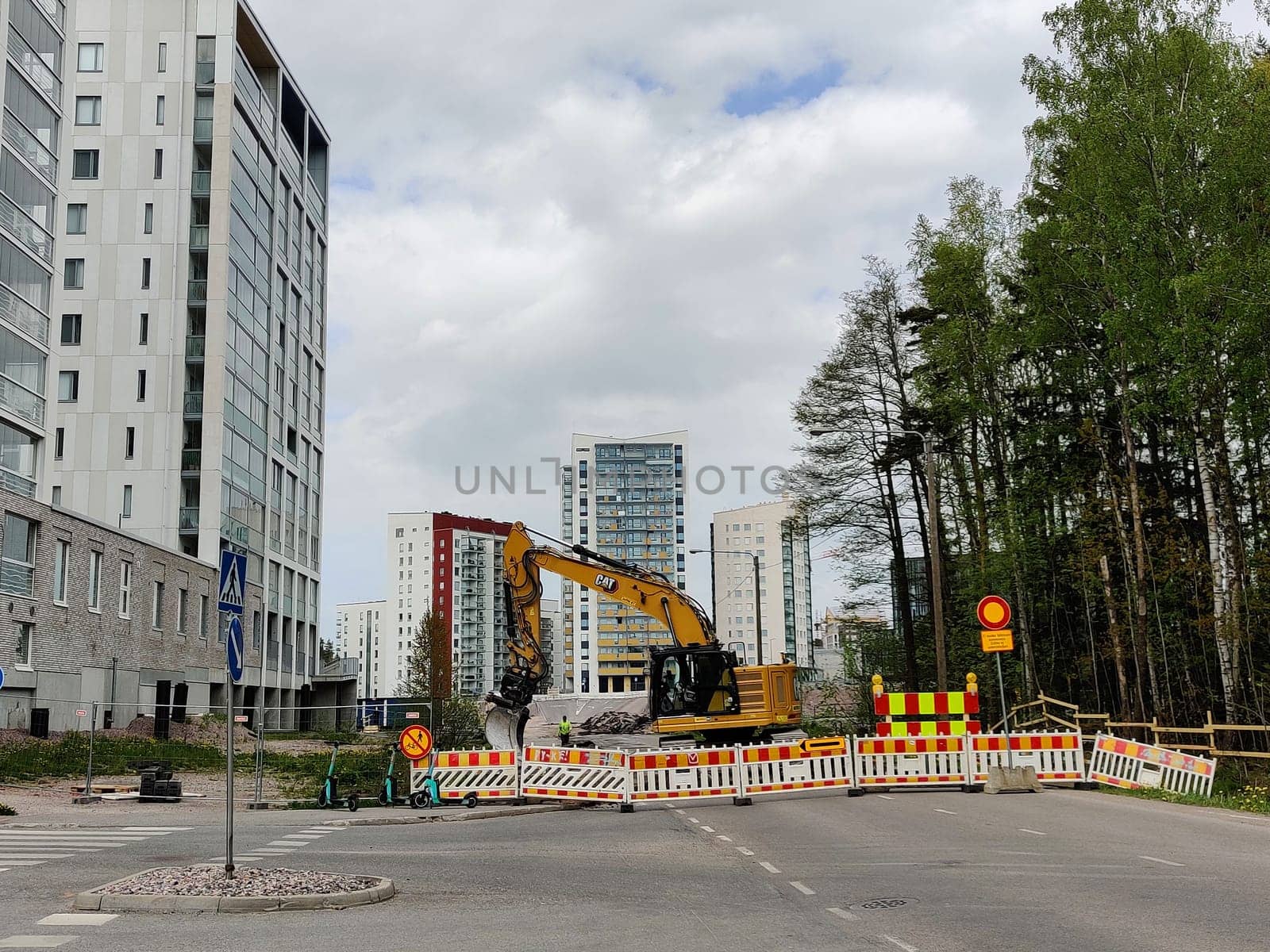 Espoo, Finland - JUNE 4th, 2025: Meritie construction in the city of Espoo, Finland, Finnoo metro station. Excavators are digging the road. The area is closed with construction barriers