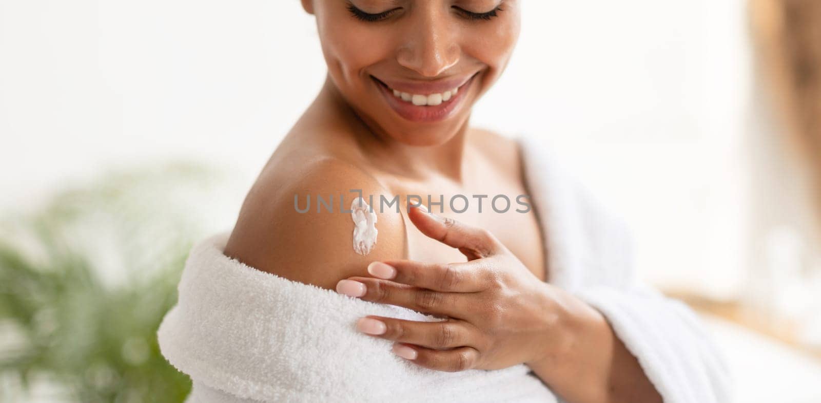 Body Care. African American Woman Applying Lotion On Shoulders Moisturizing Skin After Shower In Modern Bathroom Indoors. Beauty And Skincare Concept. Panorama, Cropped