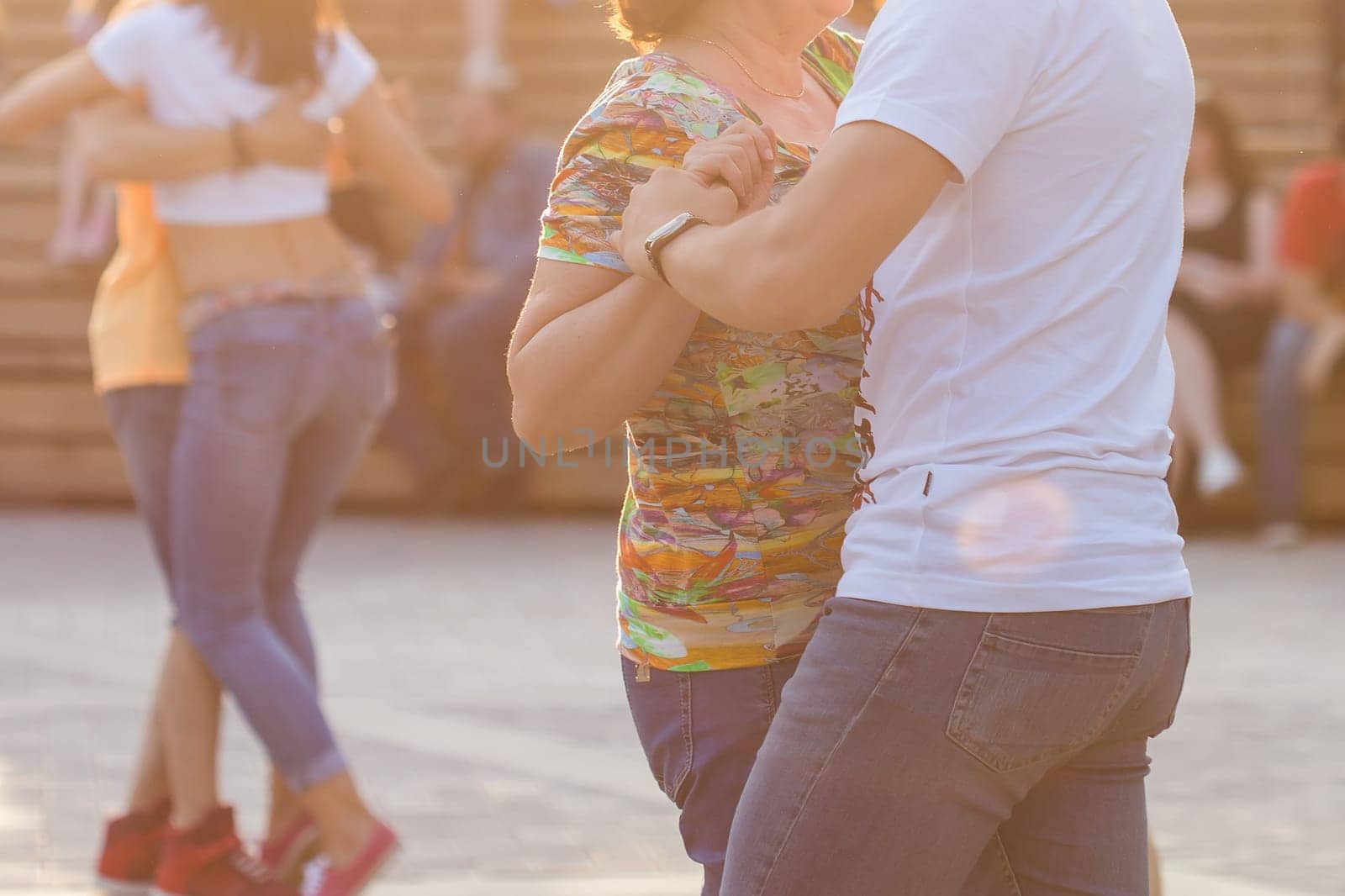 Kizomba, bachata or salsa concept - beauty couple dancing social dance on open air party