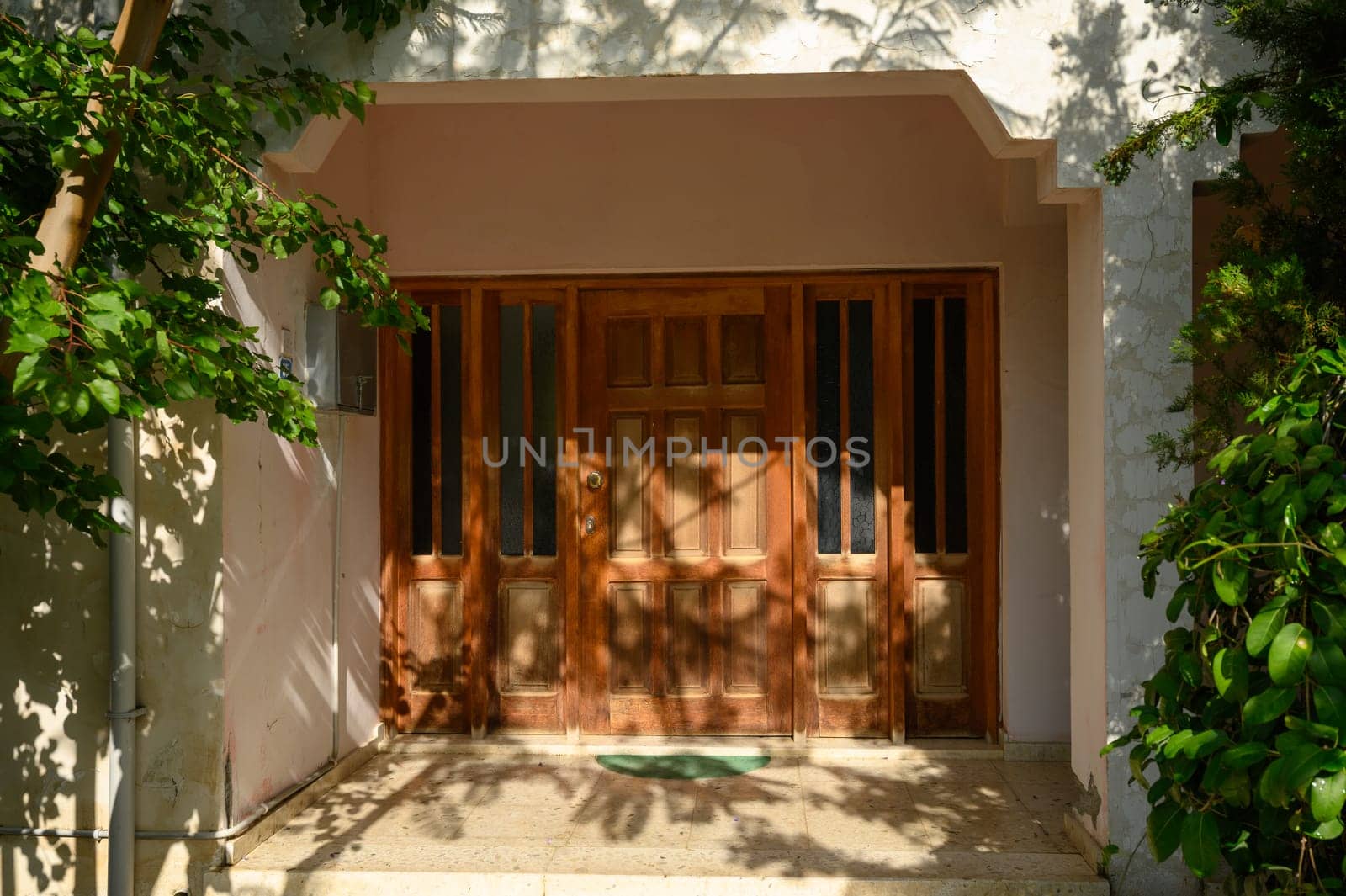 Charming entrance to a traditional Cypriot house with wooden doors and decorative elements, reflecting Mediterranean style and local heritage.