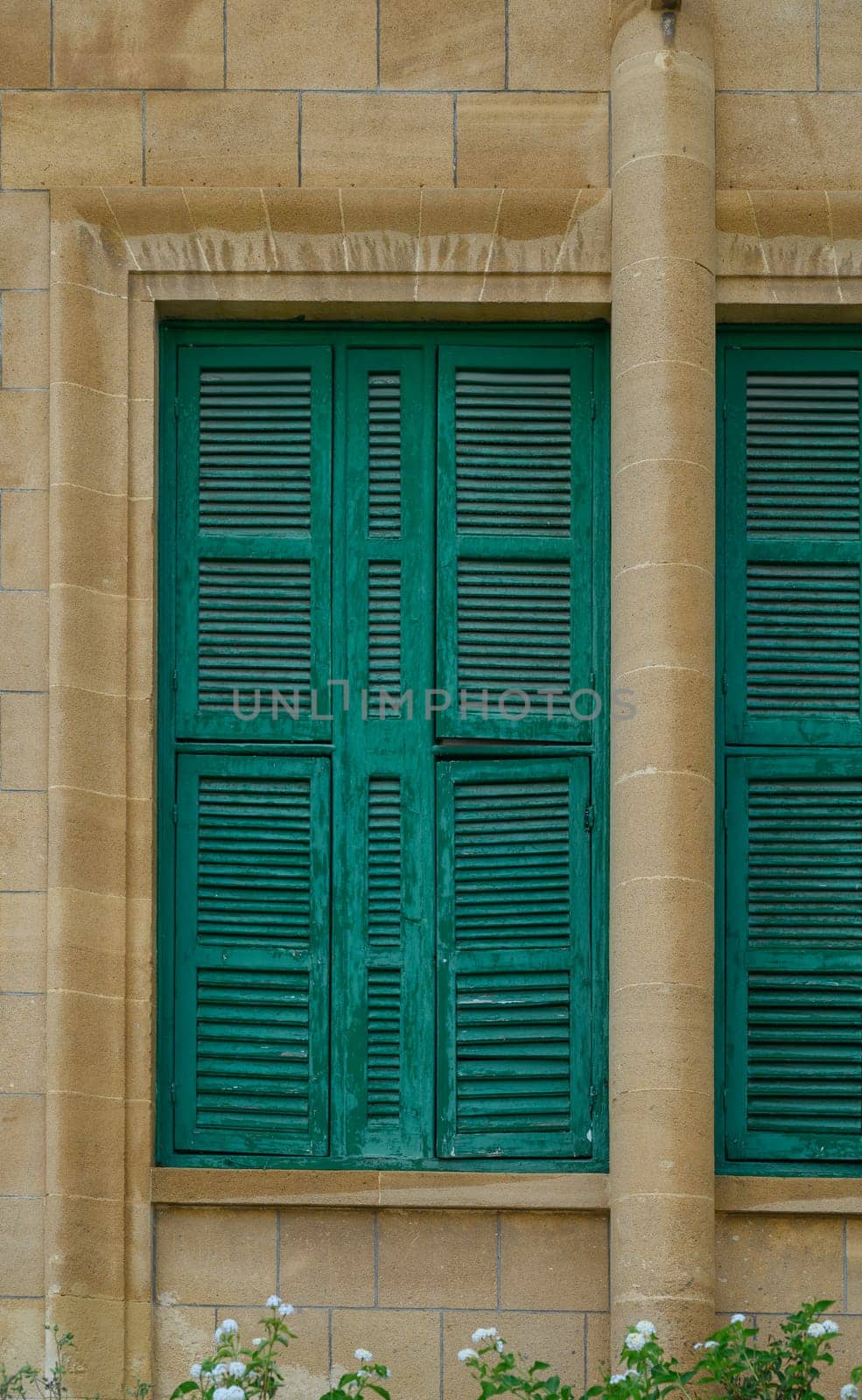 Old Stone Building with Green Shutters on Windows in Cyprus