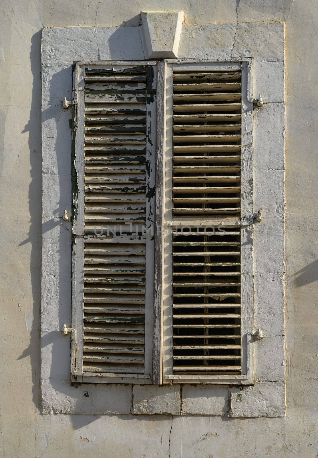 White Window with Wooden Shutters on Traditional Cyprus House