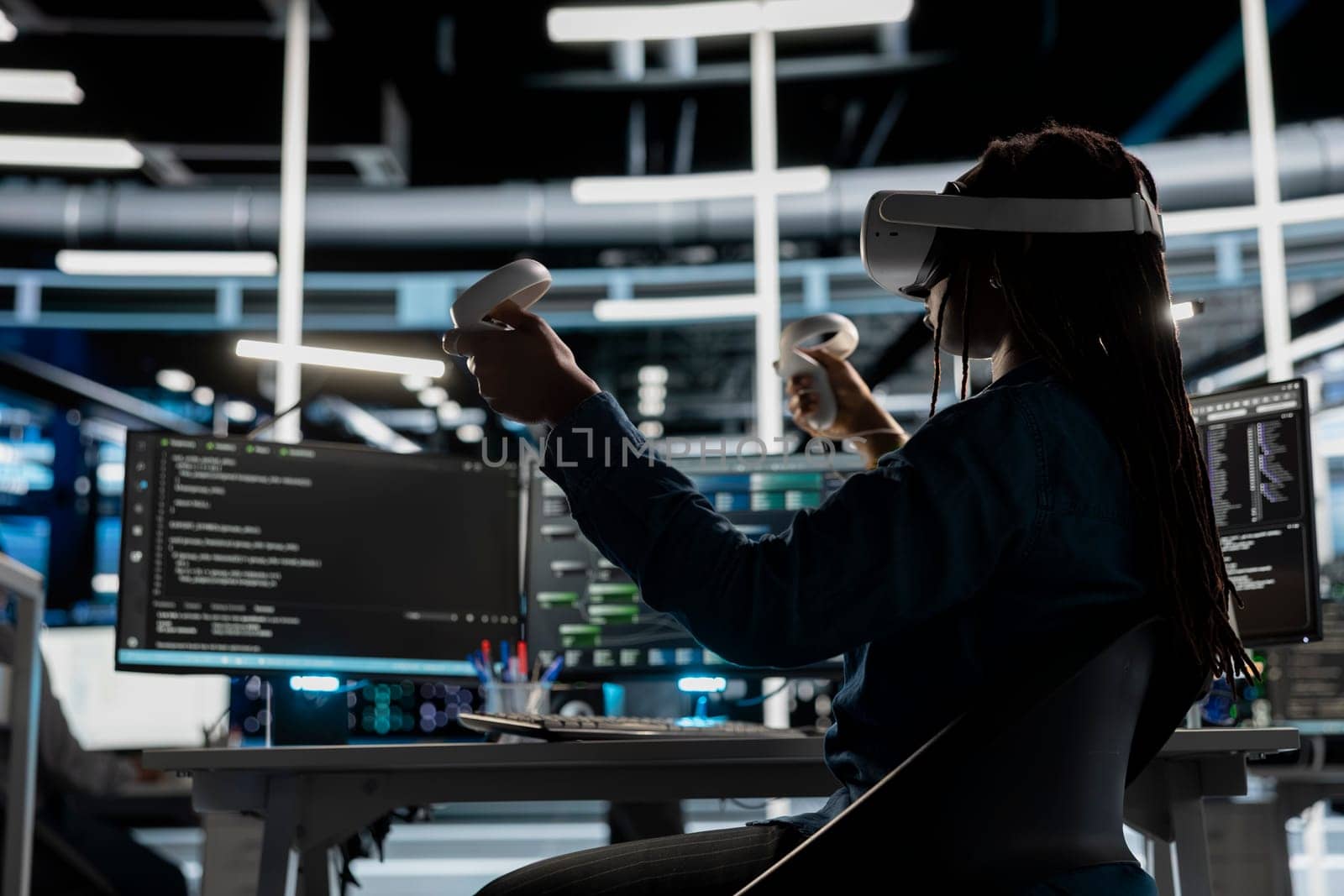 Data center admin using virtual reality to setup machine learning systems handling information. IT specialist using VR headset to train neural networks to improve server farm operations
