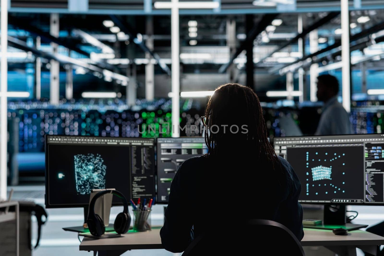 Data center software developer using artificial intelligence visualization tools on device to identify errors. Server hub staff member looking at AI generated insights to detect hardware failures