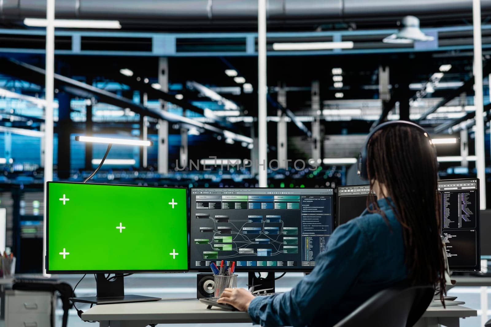 Programmer in data center using isolated screen computer to check equipment performance upgrading infrastructure. IT expert doing maintenance on supercomputers in servers room using chroma key PC
