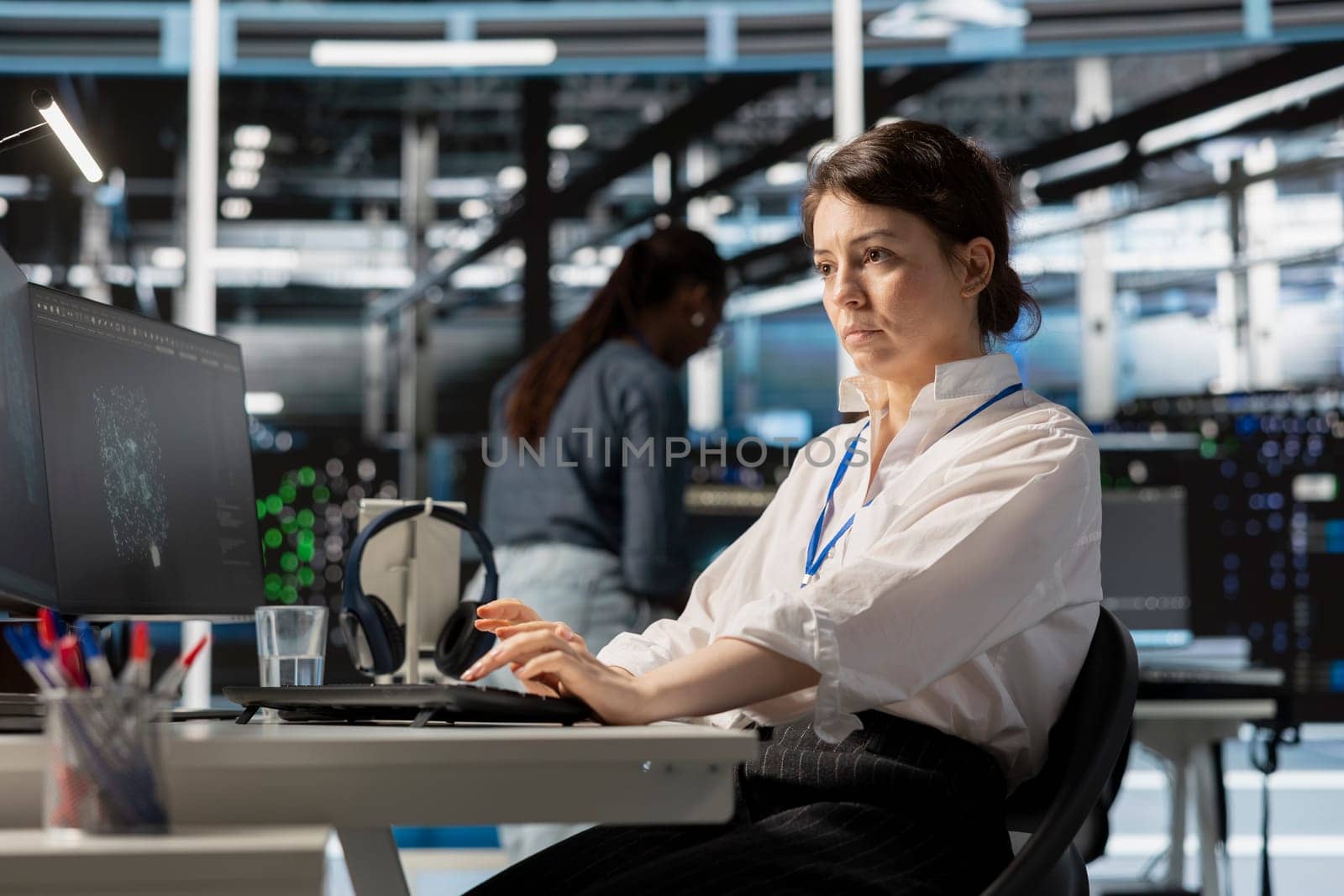 Data center computer scientist uses PC to update servers tech, configuring gear using software. Server hub IT professional reviewing hardware analytics, ensuring reliable network operations