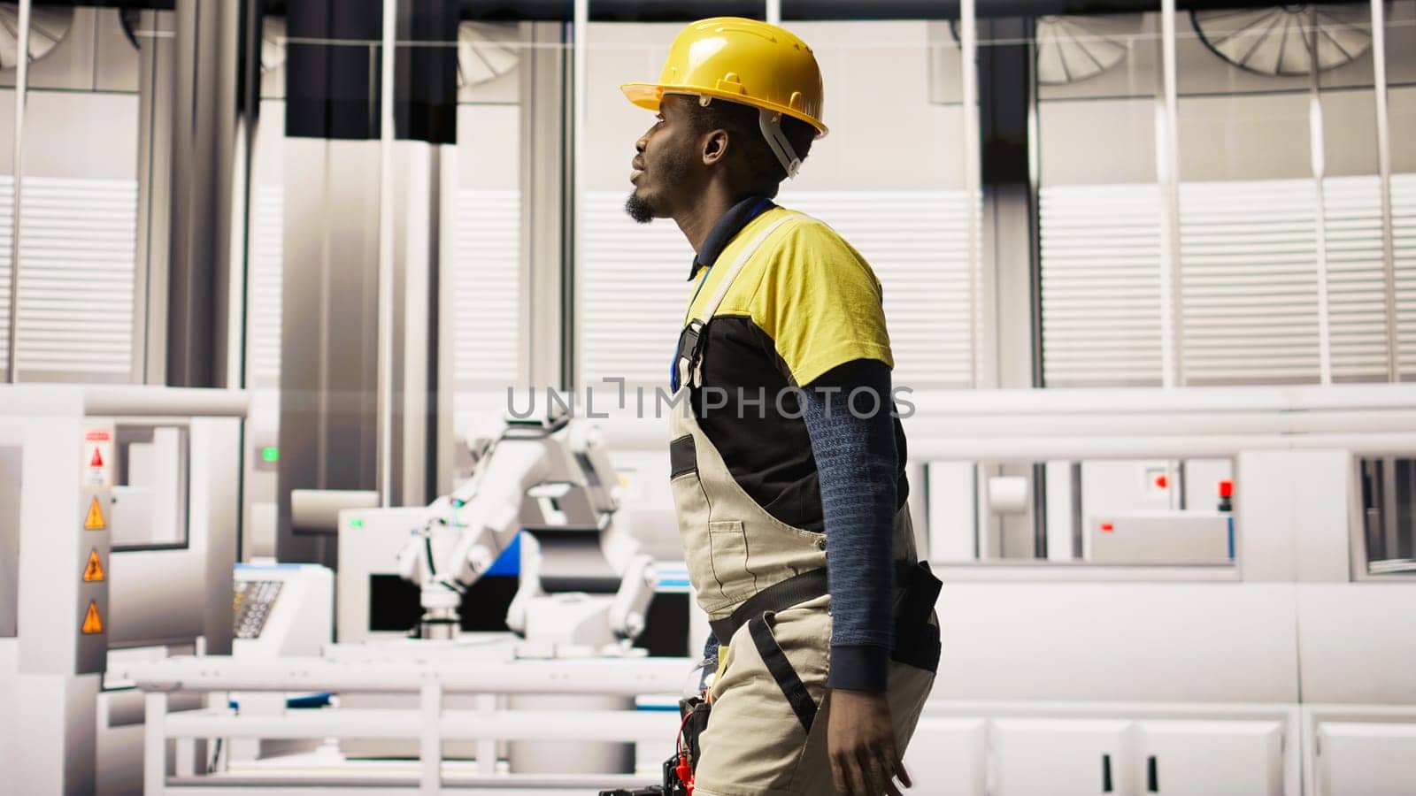 Technician holding toolbox walking in factory, overseeing solar panel production lines equipment. Engineering expert maintaining photovoltaic assembly systems in automated industrial plant, camera A