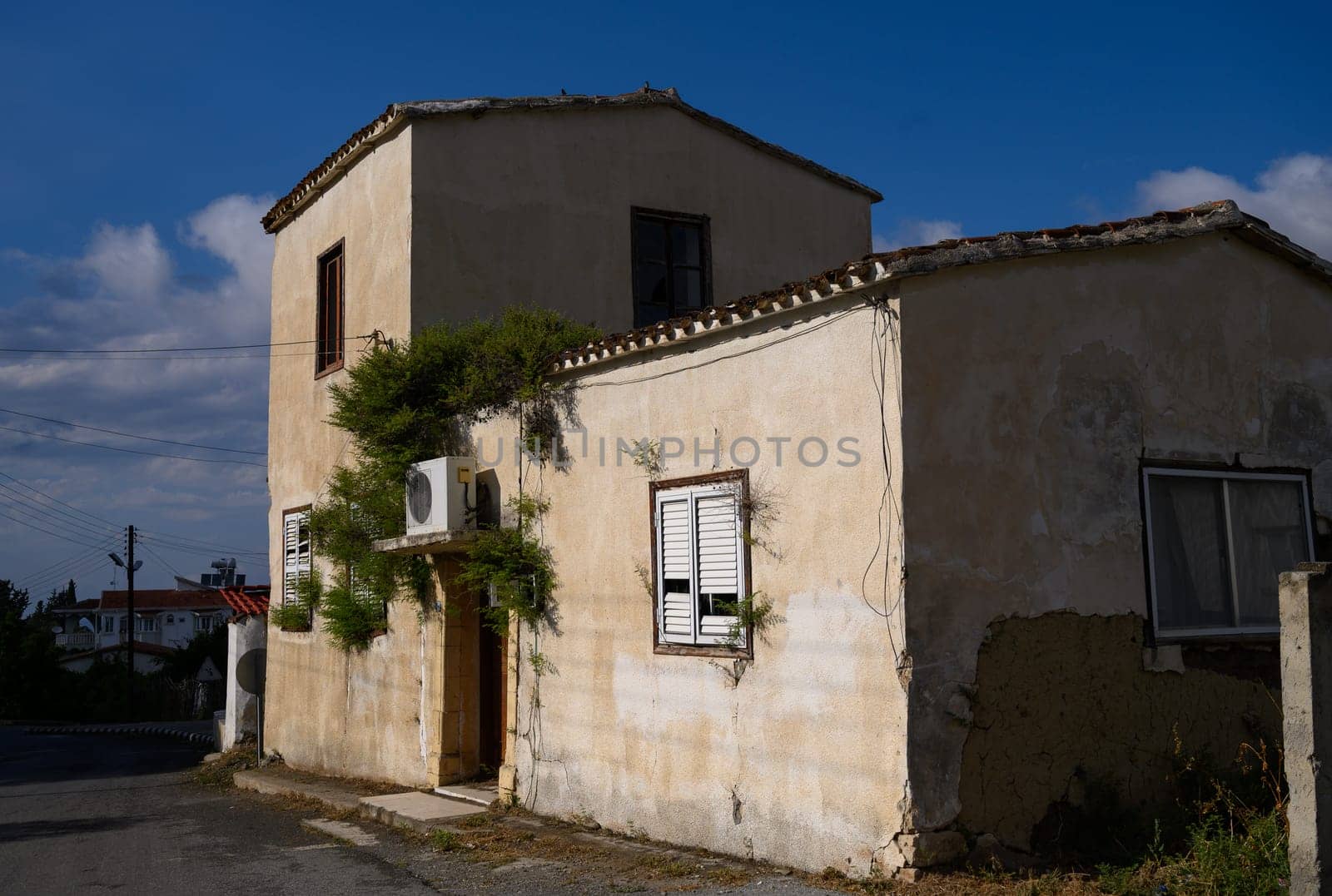 Picturesque narrow street in Lefke, lined with stone houses and aged wooden doors, typical of Cyprus.
