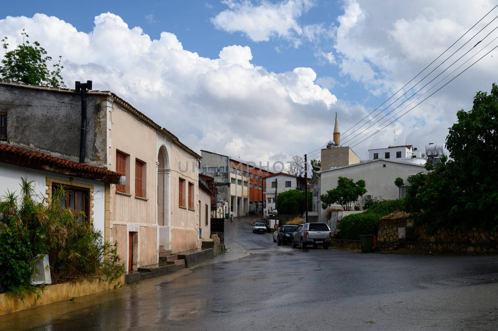 A gentle rain falls on the quiet streets of Cyprus, creating reflections and a calm atmosphere in the old town.