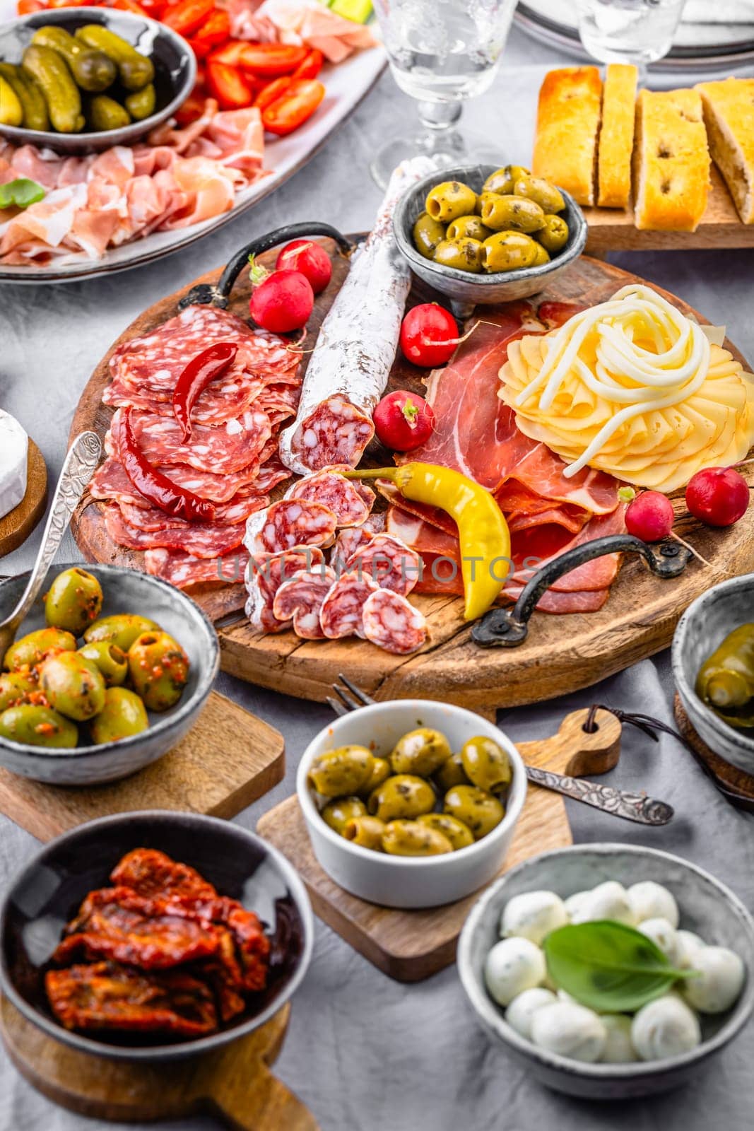 Assorted appetizers and antipasti platters on wooden tray, catering concept with meats and cheese