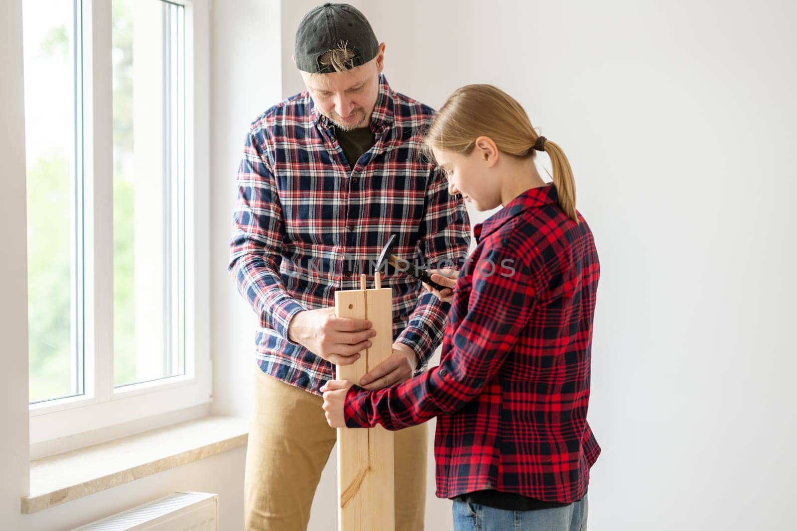 Dad Teaching Daughter To Assemble Furniture At Home