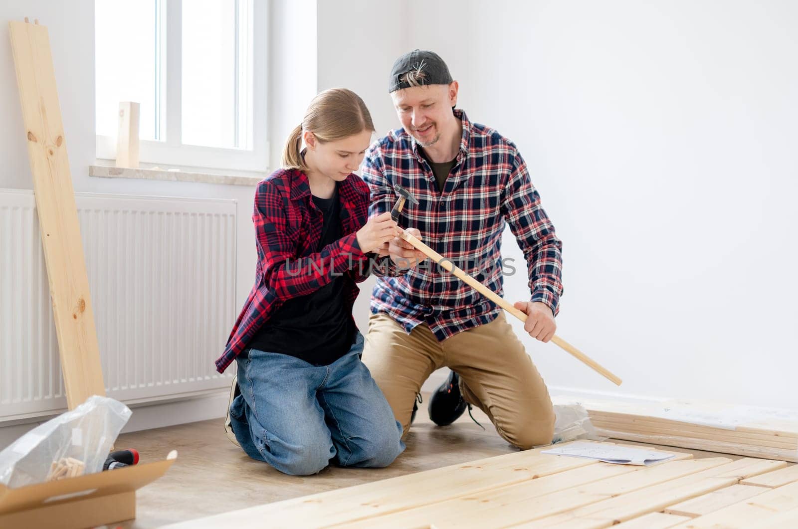 Dad And Daughter Building A Table At Home