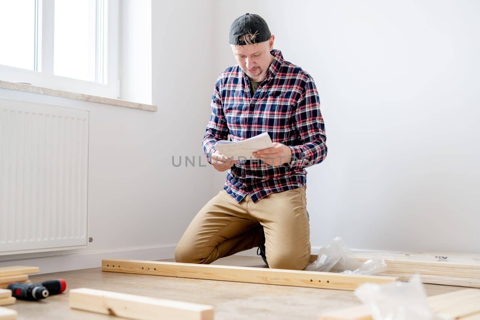 Craftsman Assembling Furniture On The Floor In A Bright Room