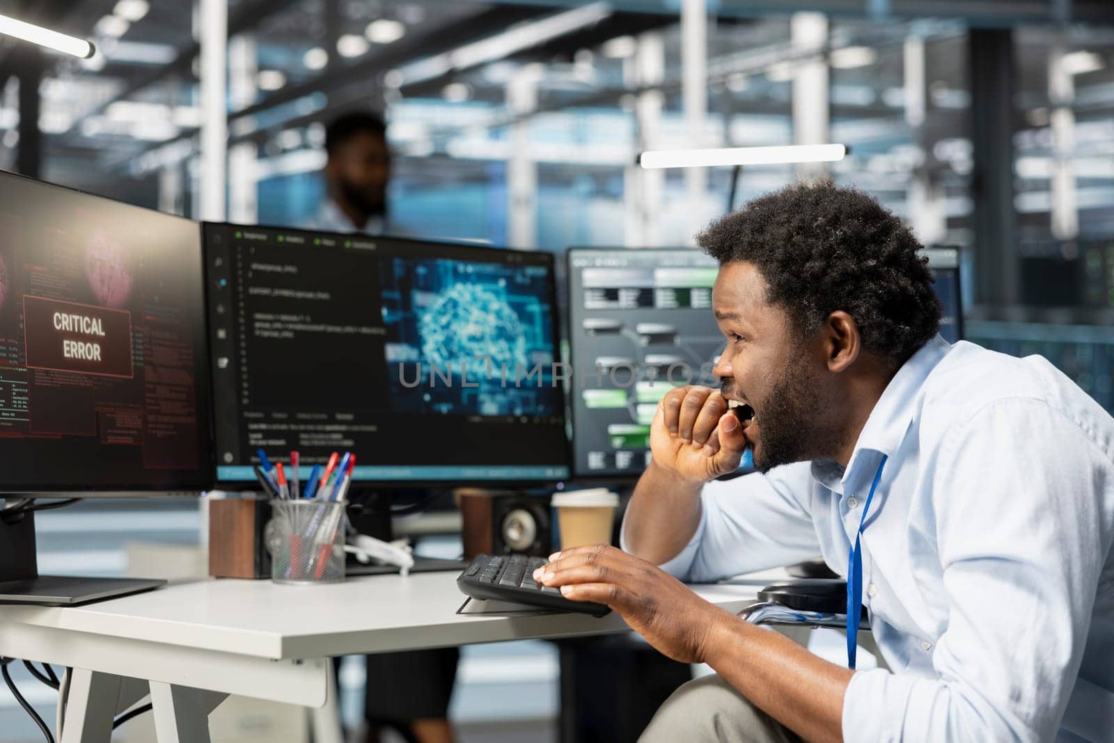 Data center system administrator panics after seeing glitch warning while using artificial intelligence model. African american man in server hub worried by errors affecting programming AI algorithms