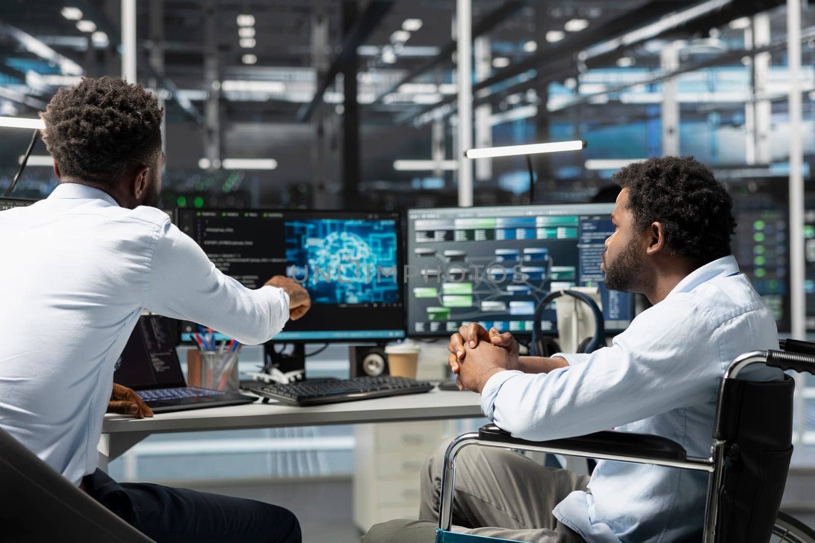 Server room manager and employee in wheelchair use artificial intelligence to perform computing tasks. Data center team leader and engineer with disability use AI for machine learning workloads