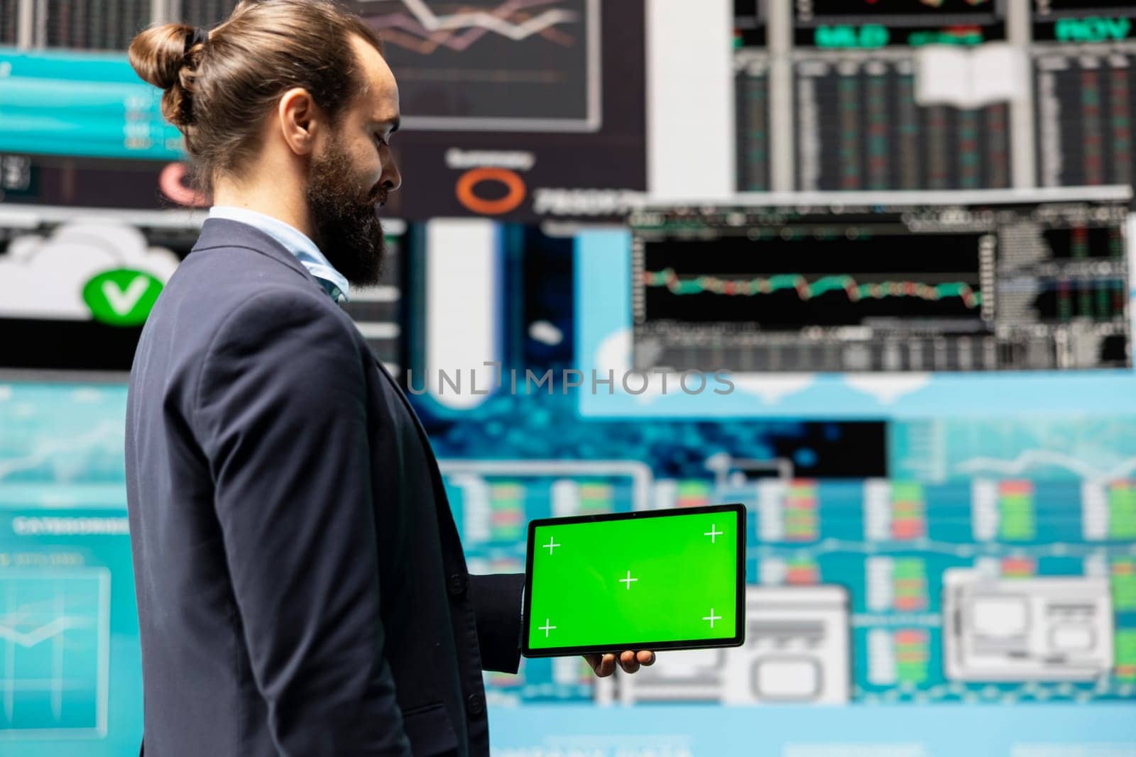 Male expert uses tablet with chroma key display leveraging dashboards, financial trends and KPI metrics optimizing company performance and planning for future success. Leadership.