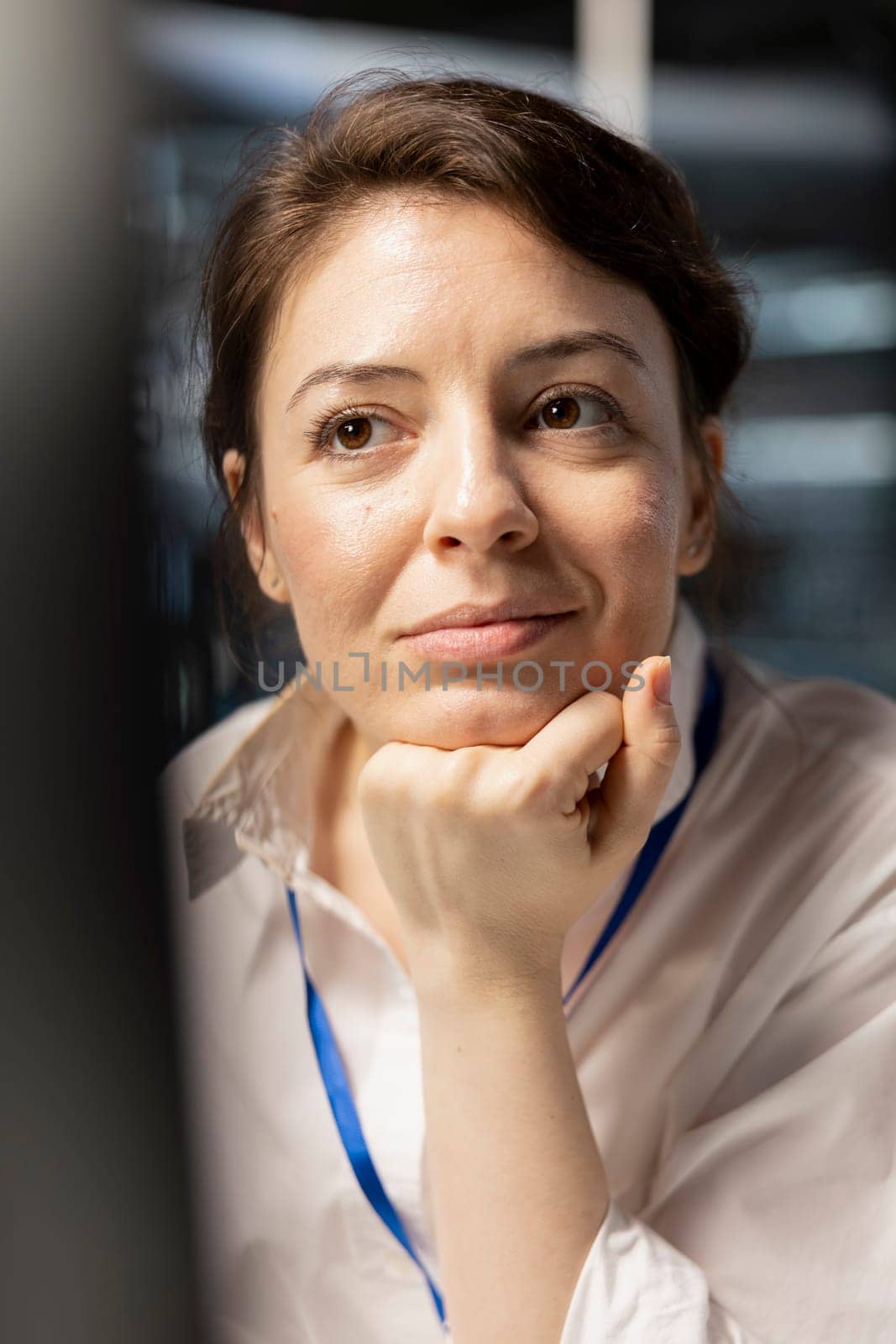 Close up of smiling data center engineer inspecting gear, doing maintenance tasks, checking performance diagnostics. Upbeat server farm IT expert conducts system checks to ensure operational stability