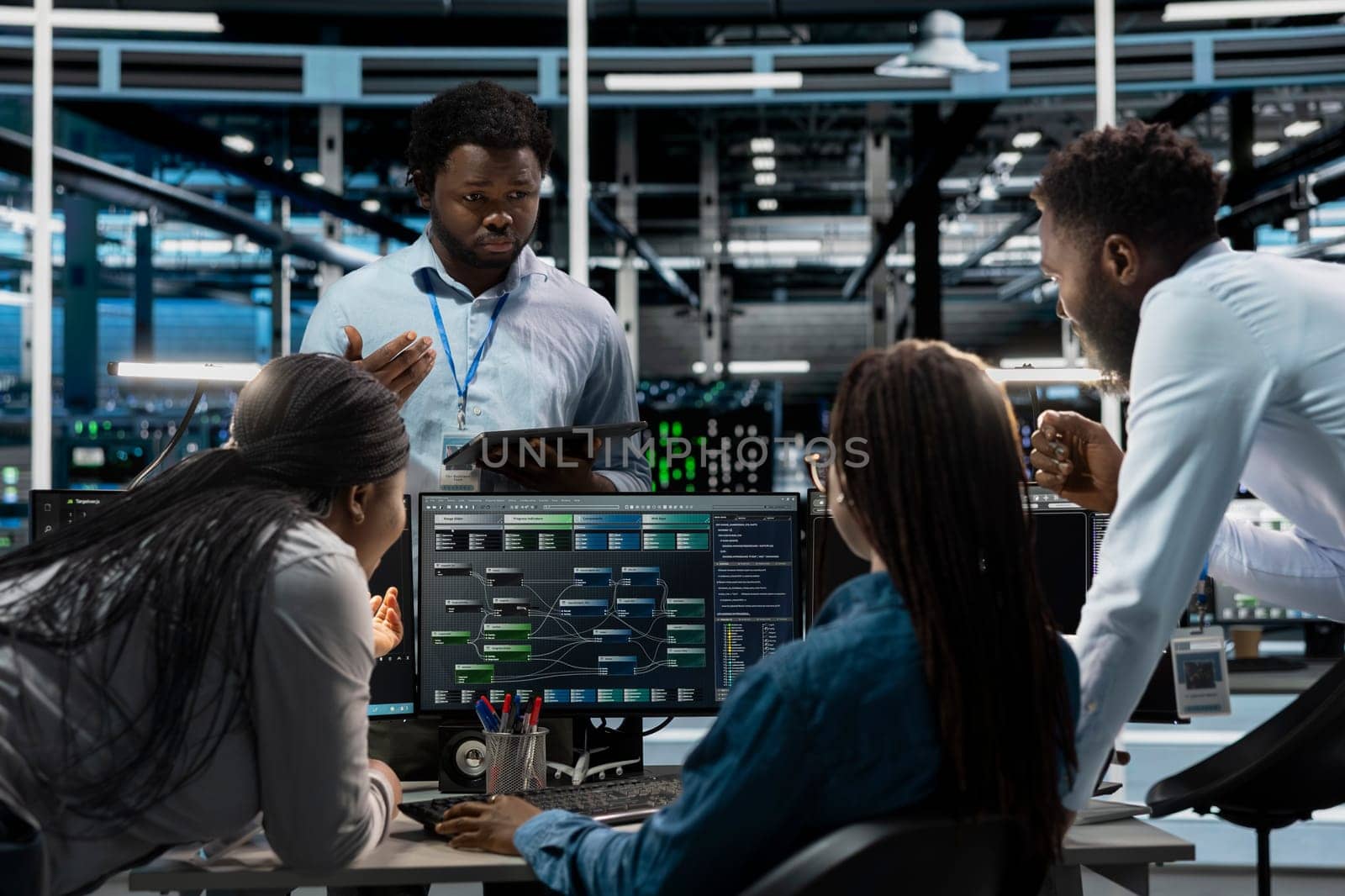 Data center system administrators using PC to visualize artificial intelligence neural networks made up of interconnected nodes. Server farm coworkers doing brainstorming, overseeing AI systems