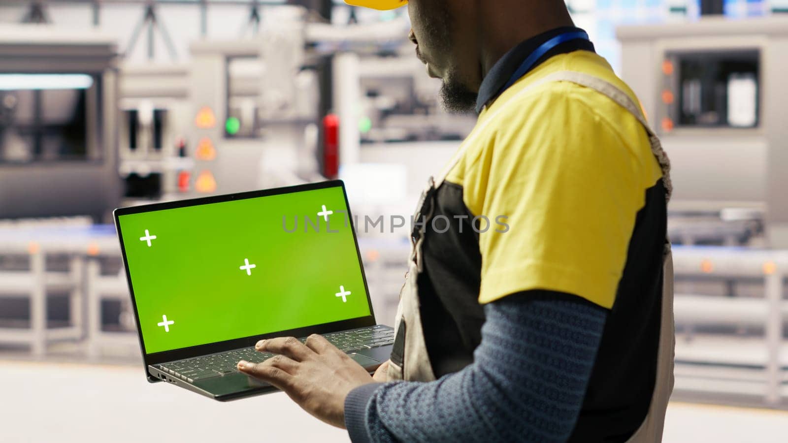 Solar panels factory engineer analyzes performance data with green screen laptop to predict gear failures. Photovoltaics plant worker uses mockup notebook to follow maintenance procedures, camera B