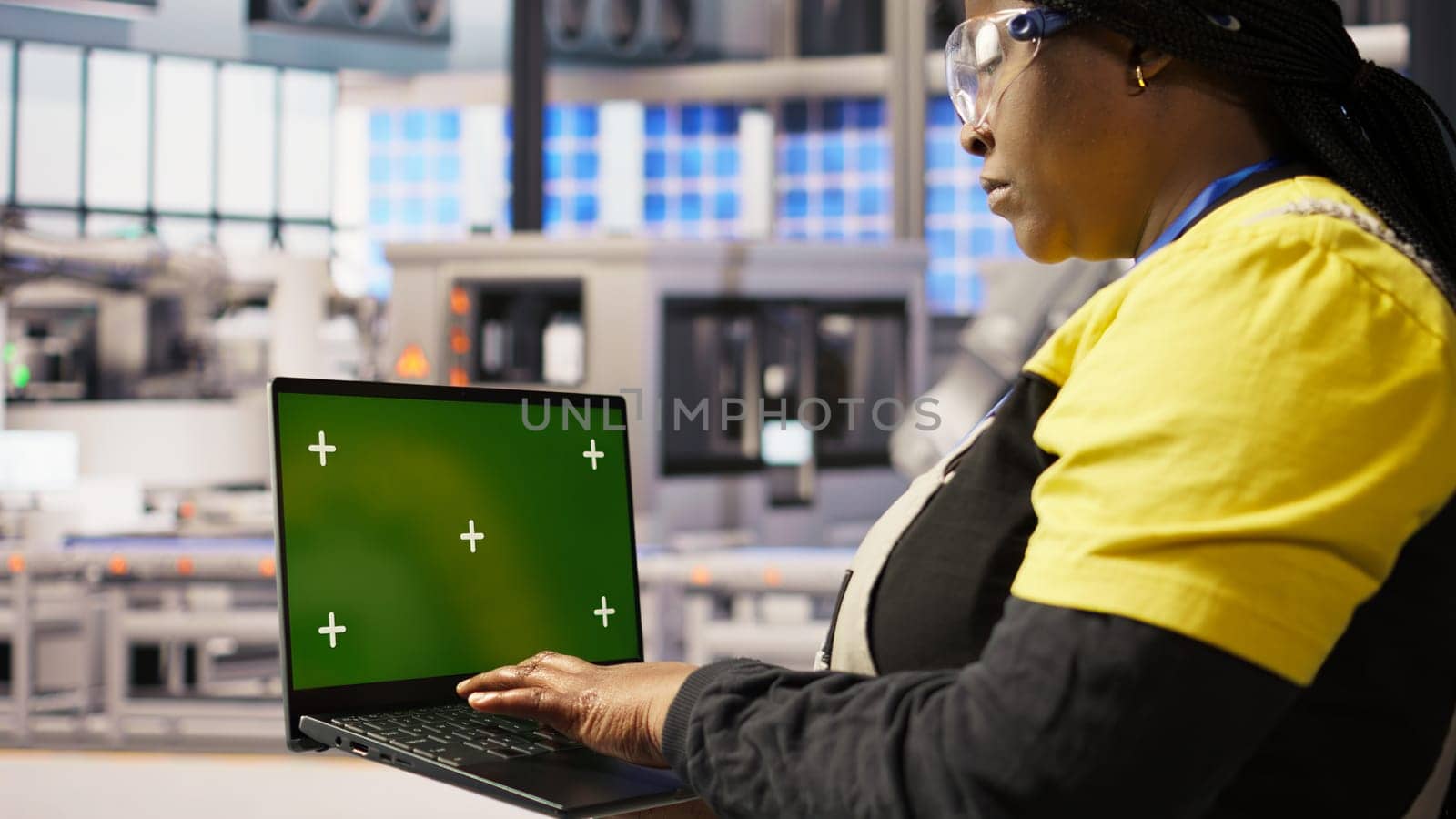 Specialist using green screen laptop to conduct inspection in renewable energy industry 4.0 plant. Technician in photovoltaics smart factory testing equipment using chroma key notebook, camera A