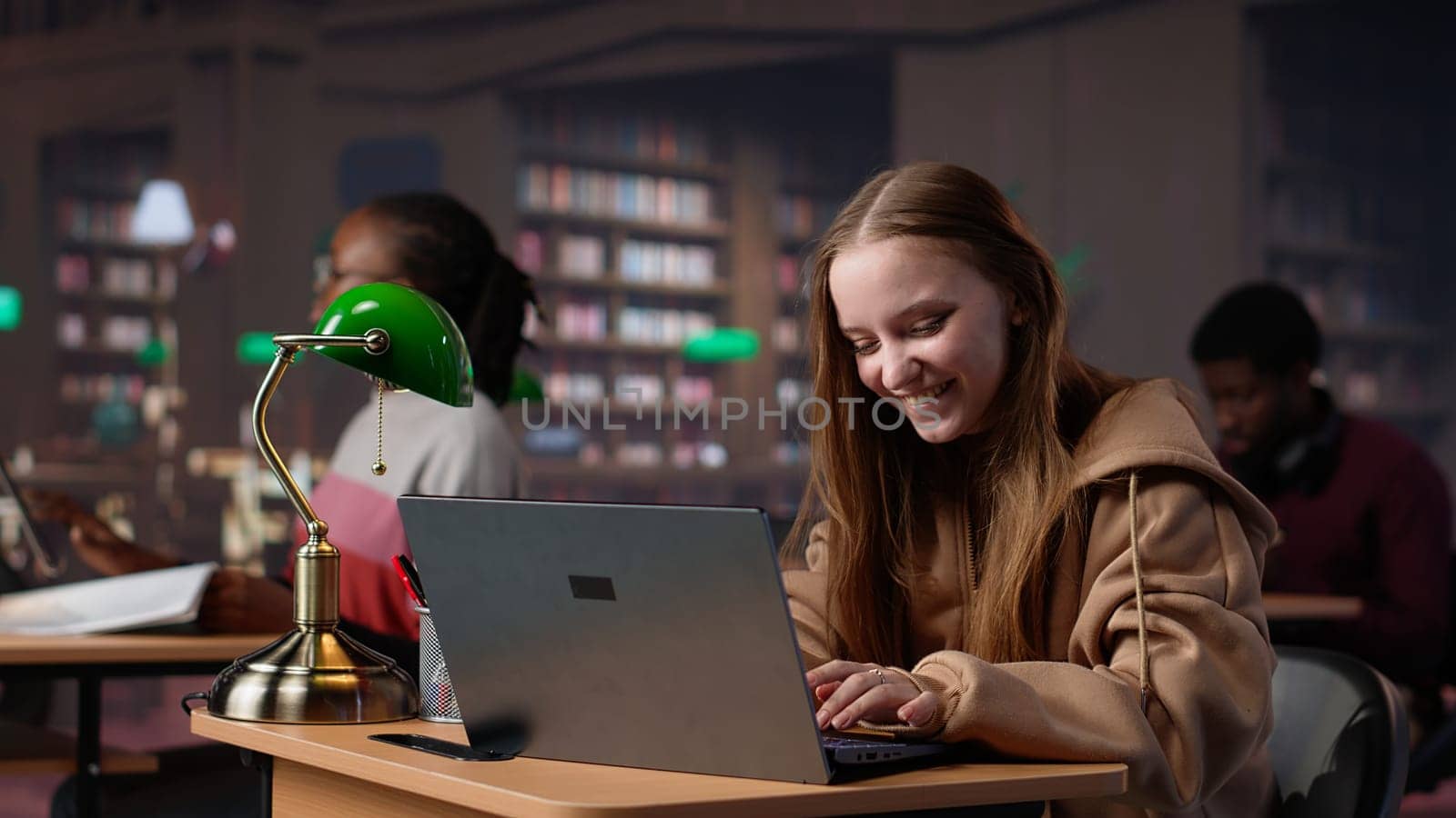 Young scholar celebrating some good news and feeling pleased with progress, finishing a school project for a high grade. Student passing her exams, peaceful campus library. Camera A.